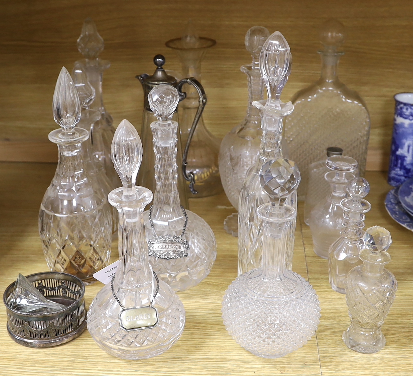 A collection of fourteen Victorian and later glass decanters, a glass funnel, a plated claret jug, coaster and scent bottle, tallest 34cm high